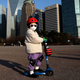 A child wears a mask to prevent catching the new coronavirus while riding a scooter on February 27, 2020 in Seoul, South Korea.